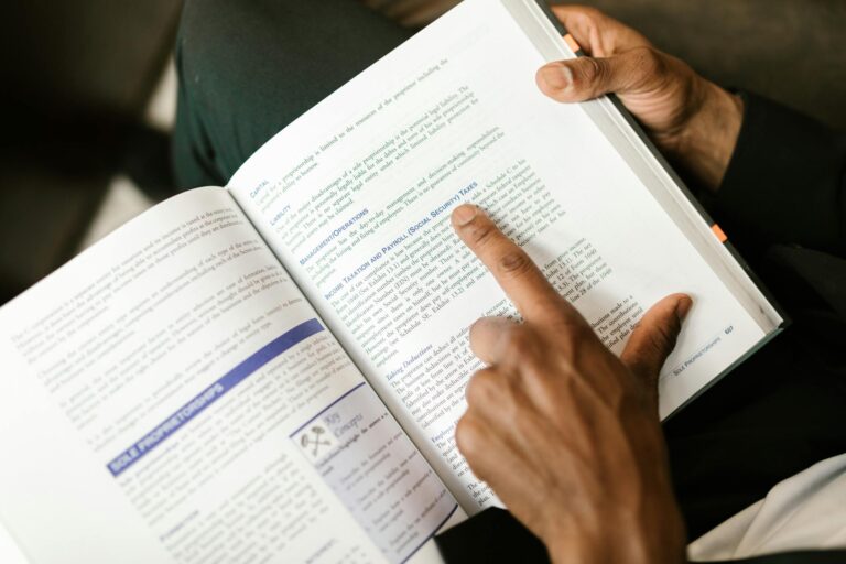 Person pointing on a Book 